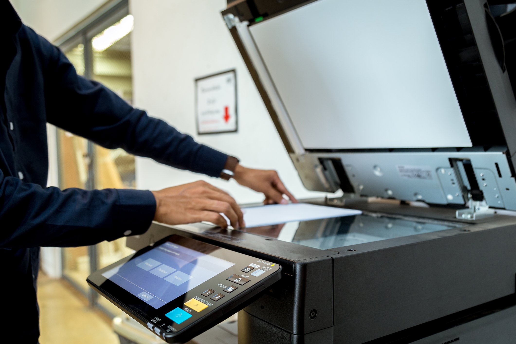 Businessman using multifunction printer (MFP)